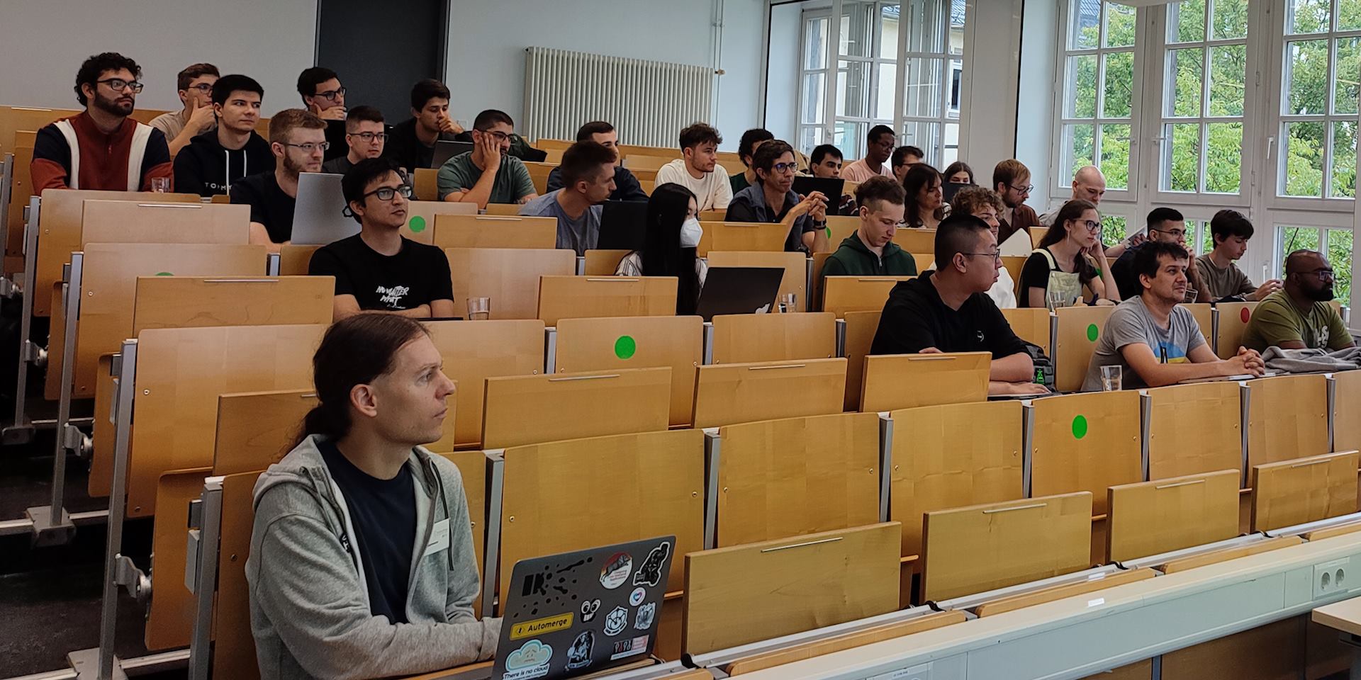 Students listen to a presentation during the ACM Europe Summer School on Distributed and Replicated Environments