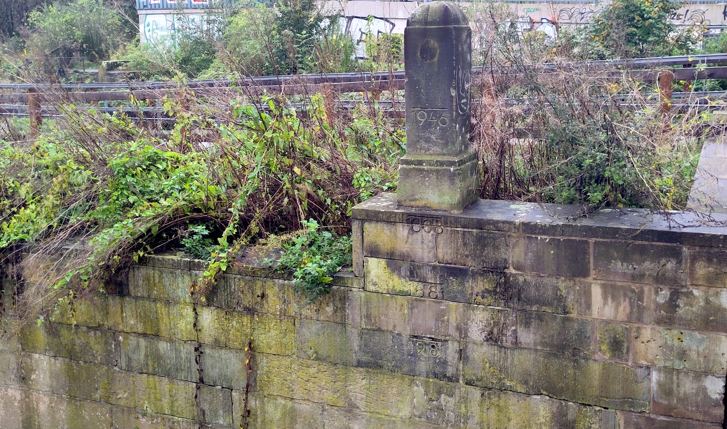 Wall with markings of years beside a river